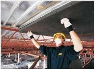 A technician servicing a garage door.